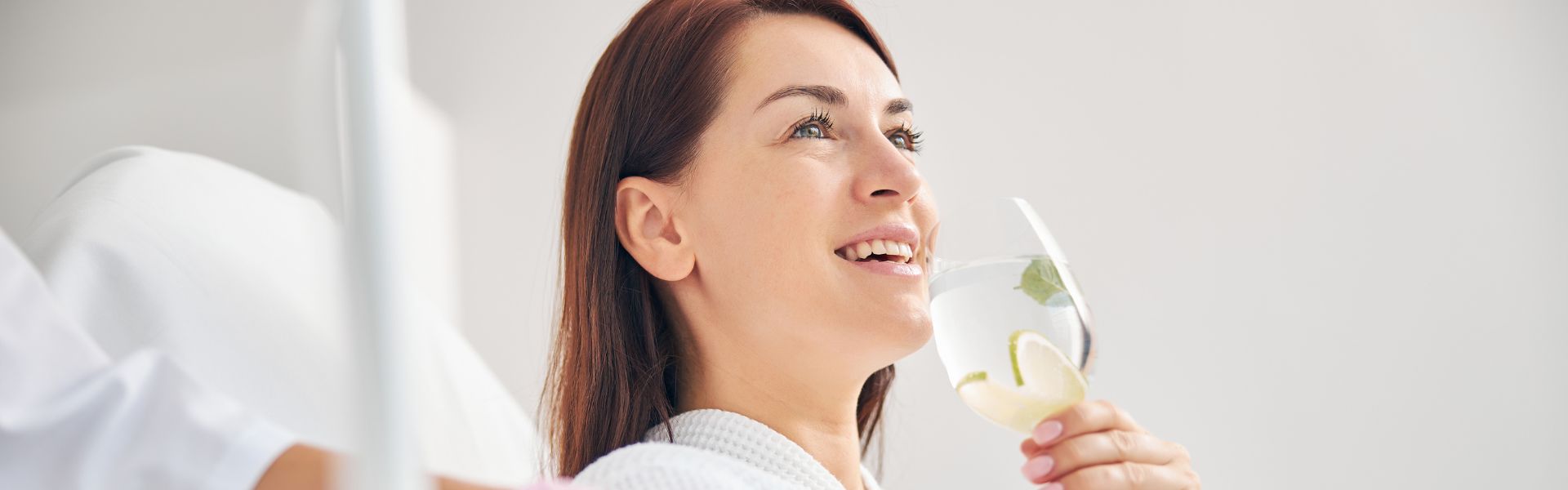 Person smiling while drinking